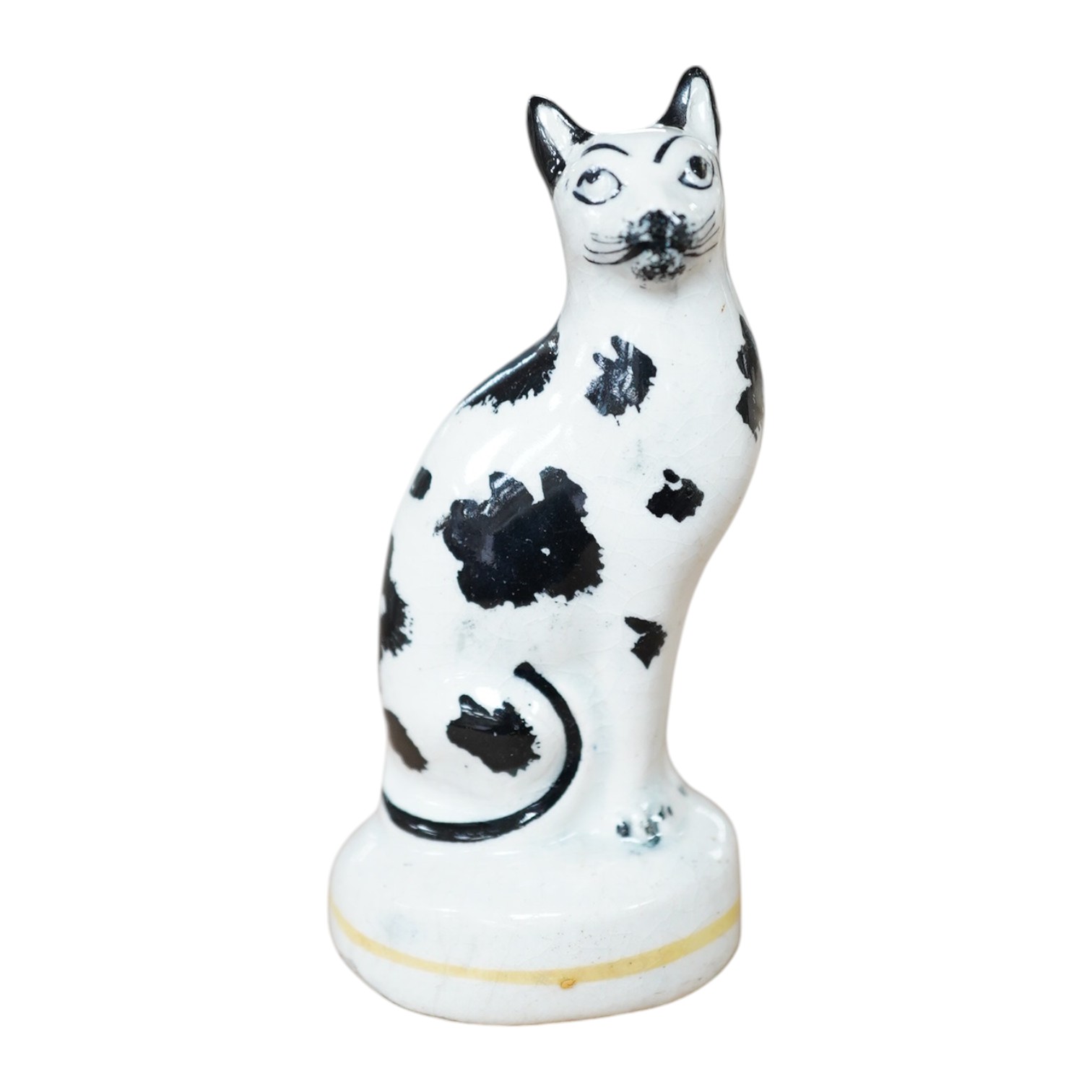 A rare Staffordshire pottery figure of a seated cat, mid 19th century, 9.5 cm high, Condition – ears restored, crack to base